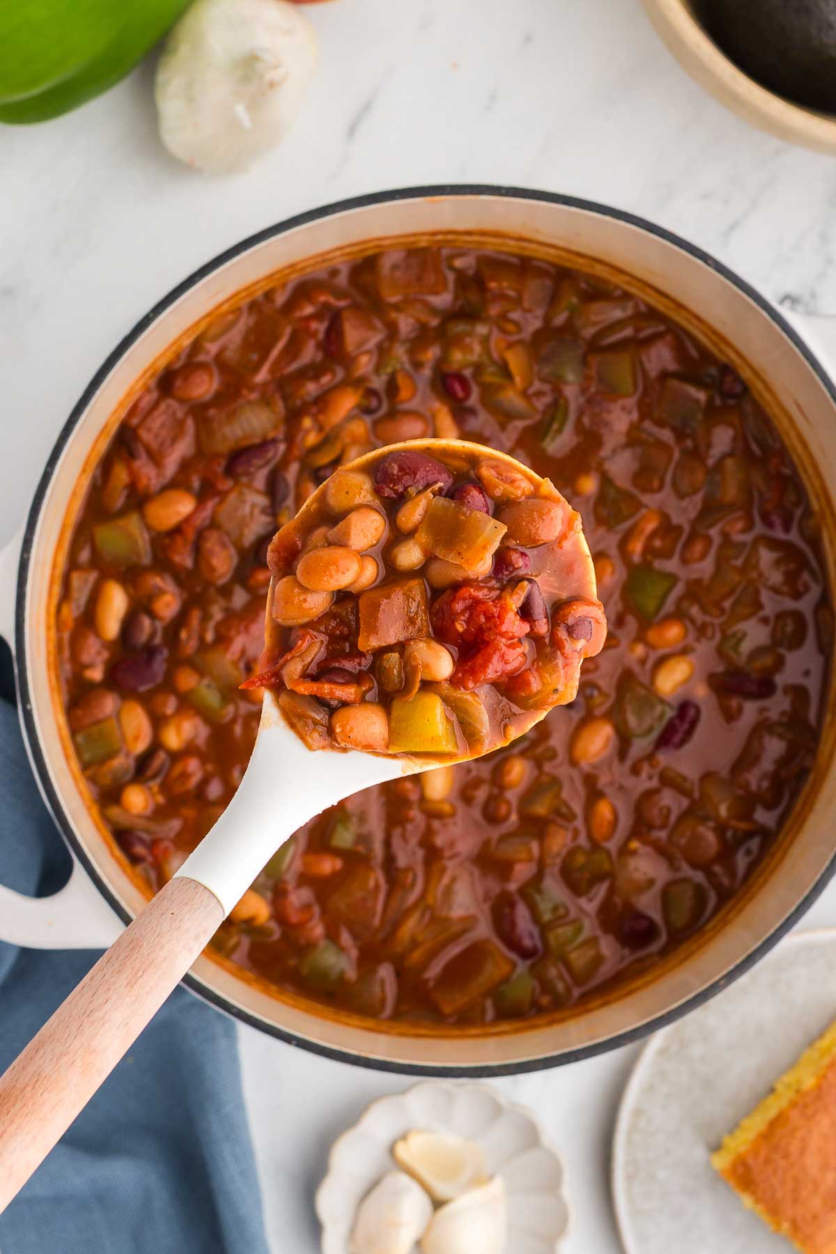 white ladle scoops out a serving of 5 Bean Chili