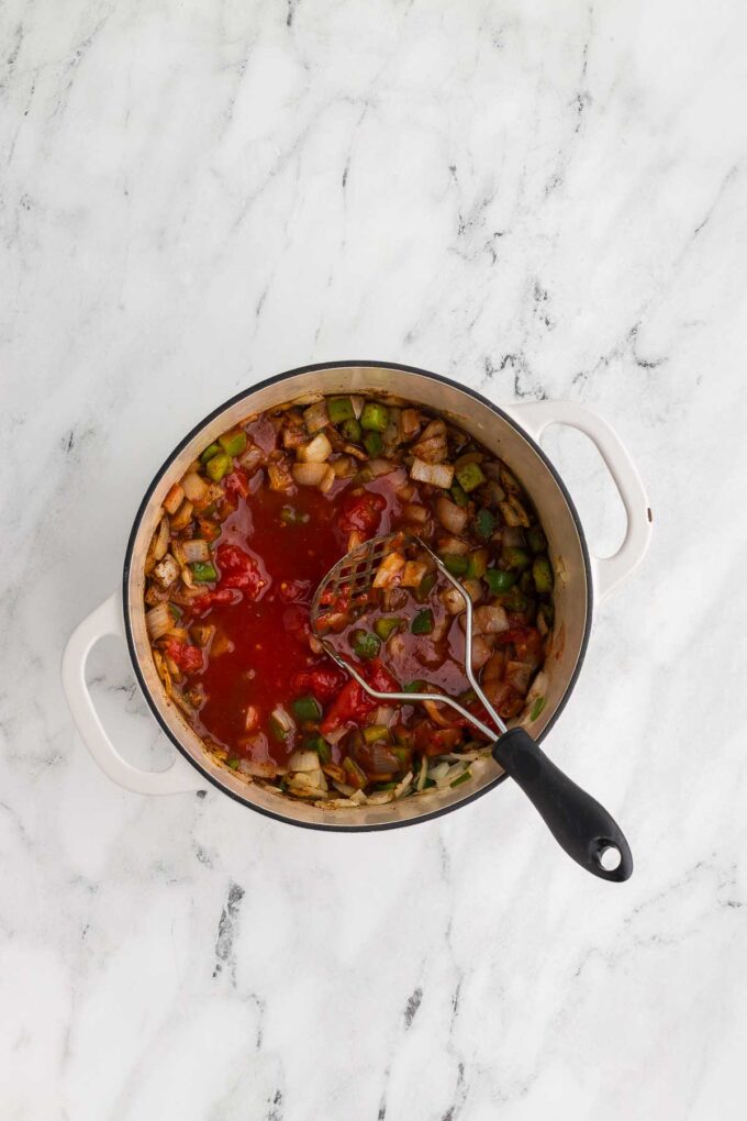 adding tomatoes to 5 Bean Chili