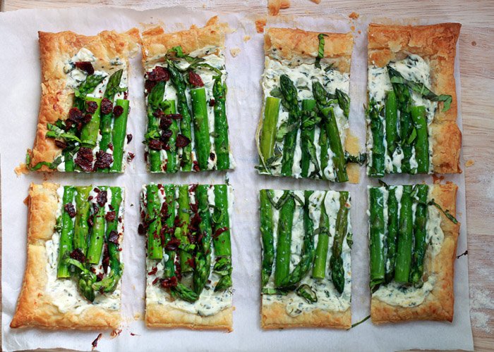 Asparagus Cream Cheese Tart recipe - Tender asparagus and tangy basil cream cheese top golden puff pastry in this easy vegetarian tart. Got carnivores too? Just top individual squares with crumbled bacon for the meat-eaters.