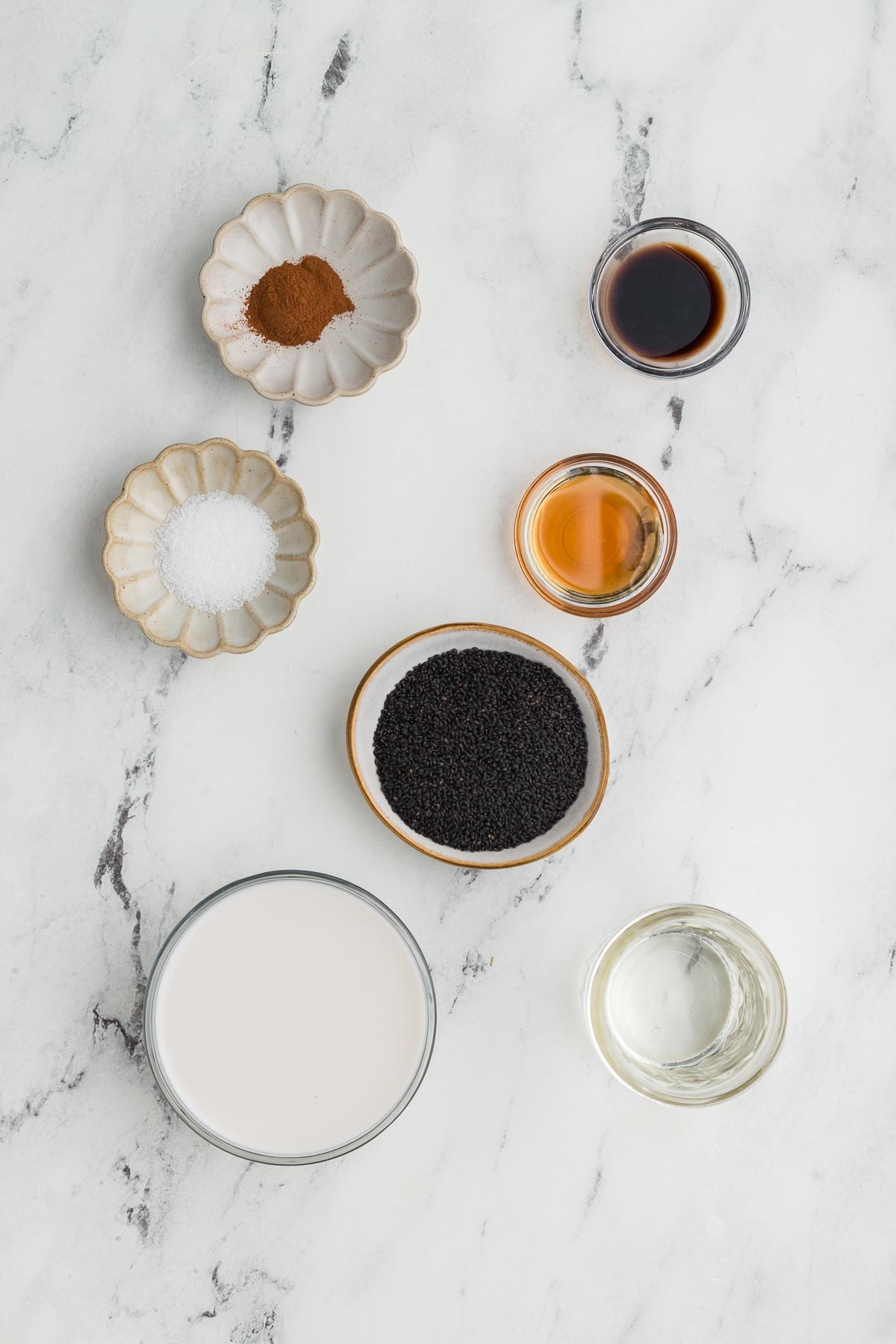 Basil Seed Pudding ingredients on a white marble background
