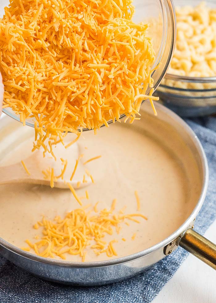 Adding cheese to the sauce for the best baked macaroni and cheese recipe ever