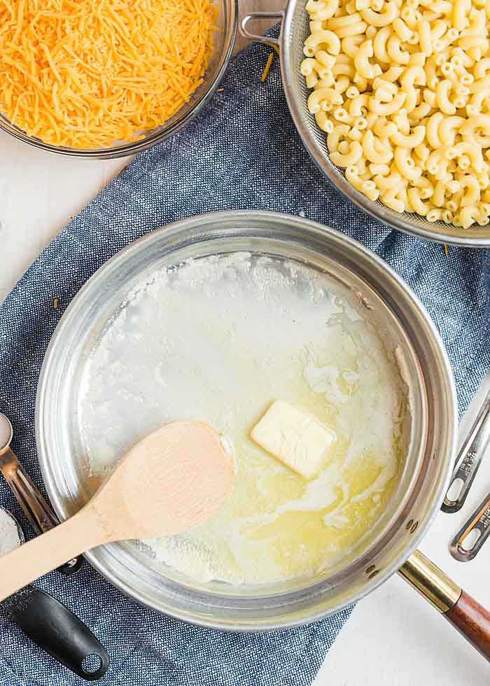 Melting butter for the roux base of the best baked mac and cheese recipe.