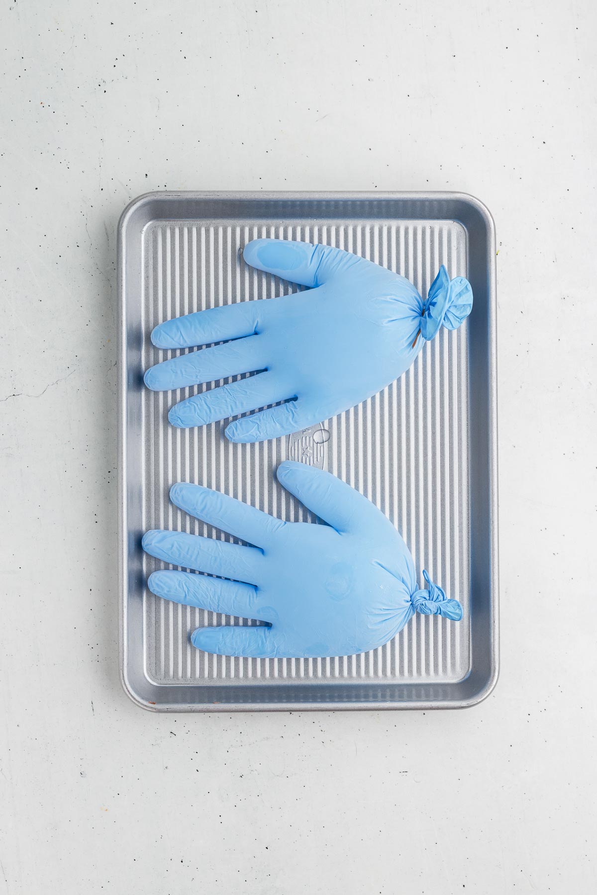 making ice hands for Black Magic Halloween Punch