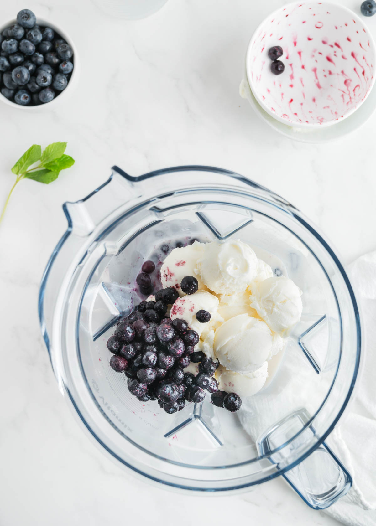Top view of ingredients in the blender for blueberry milkshakes