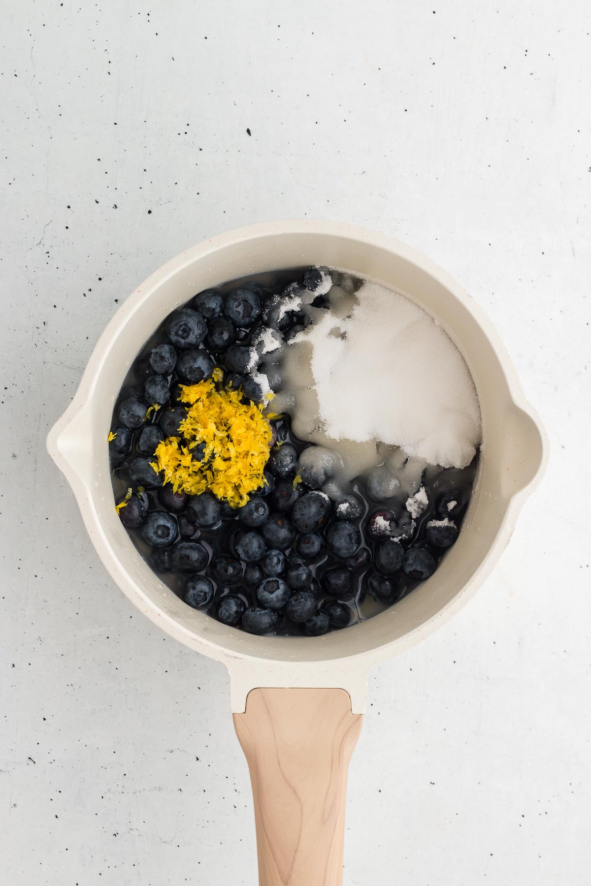ingredients for blueberry sauce in a saucepan ready to cook