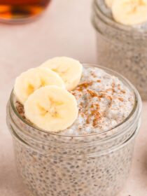 Chai Latte Basil Seed Pudding in a mason jar with cinnamon and sliced bananas