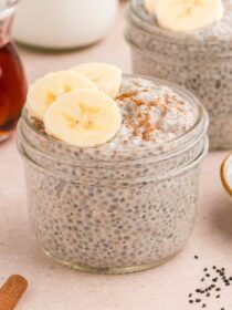 Chai Basil Seed Pudding in small mason jars with cinnamon and sliced bananas