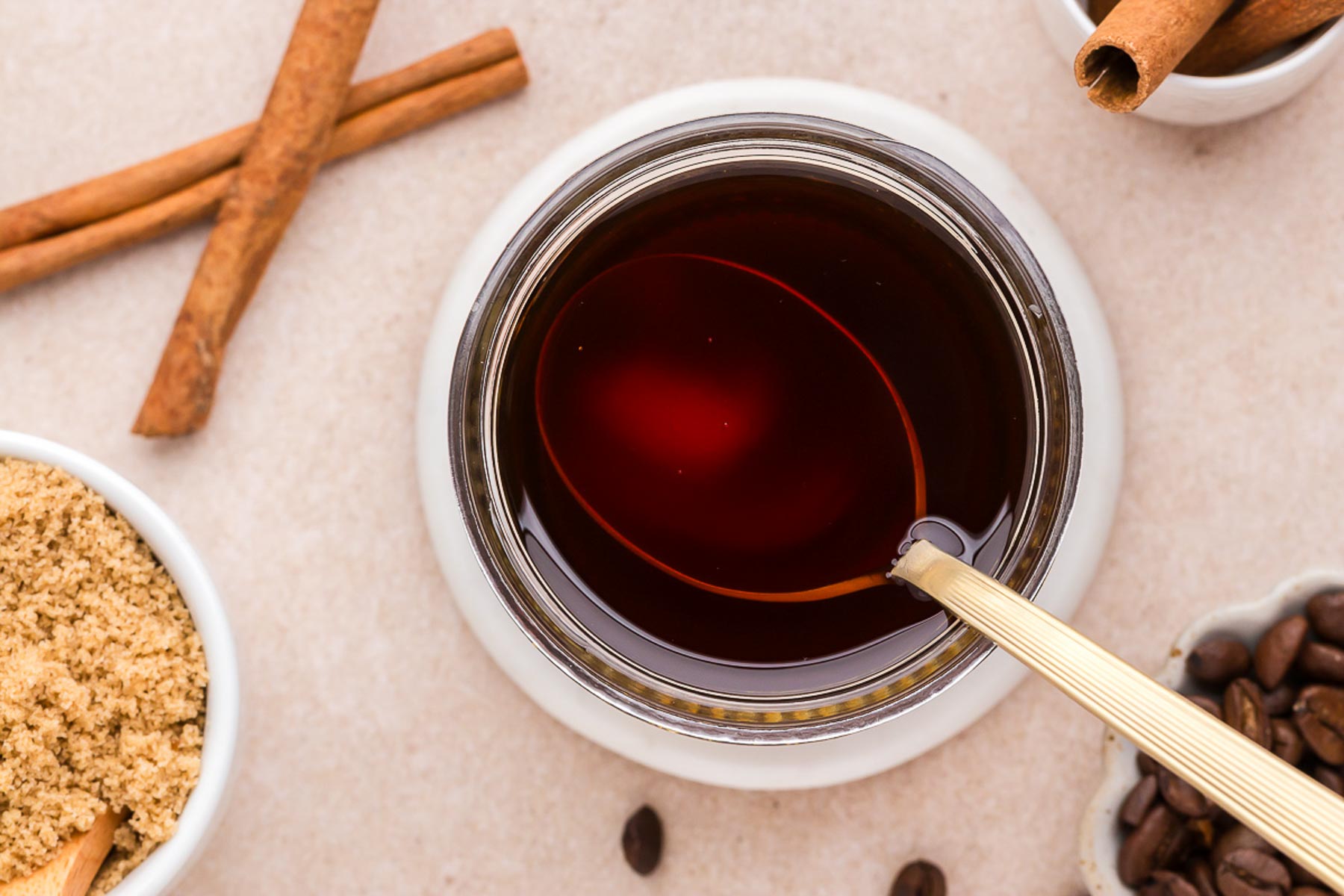 Cinnamon Dolce Coffee Syrup in a jar with a spoon