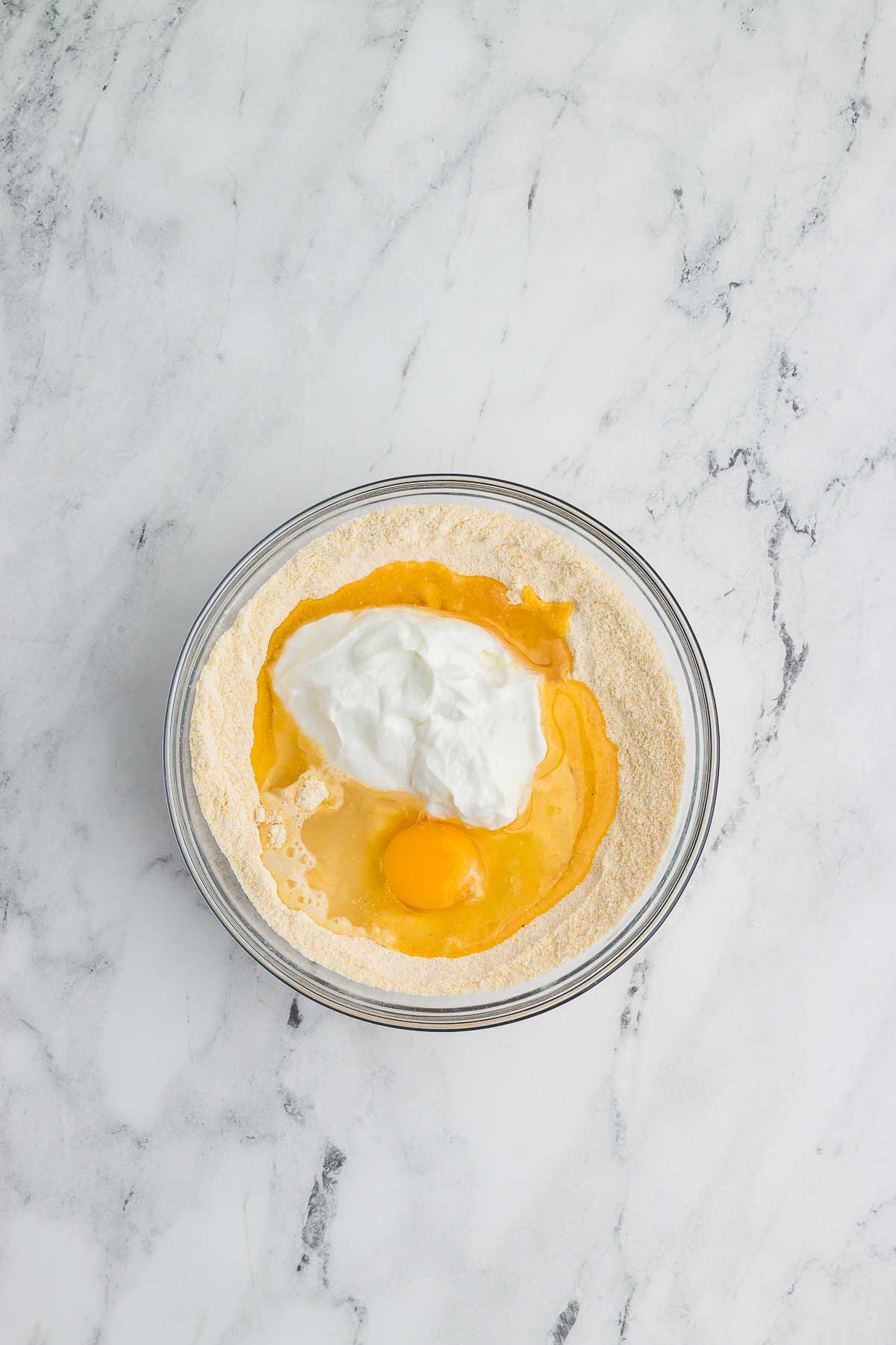 how to make Homemade Cornbread - add eggs and greek yogurt