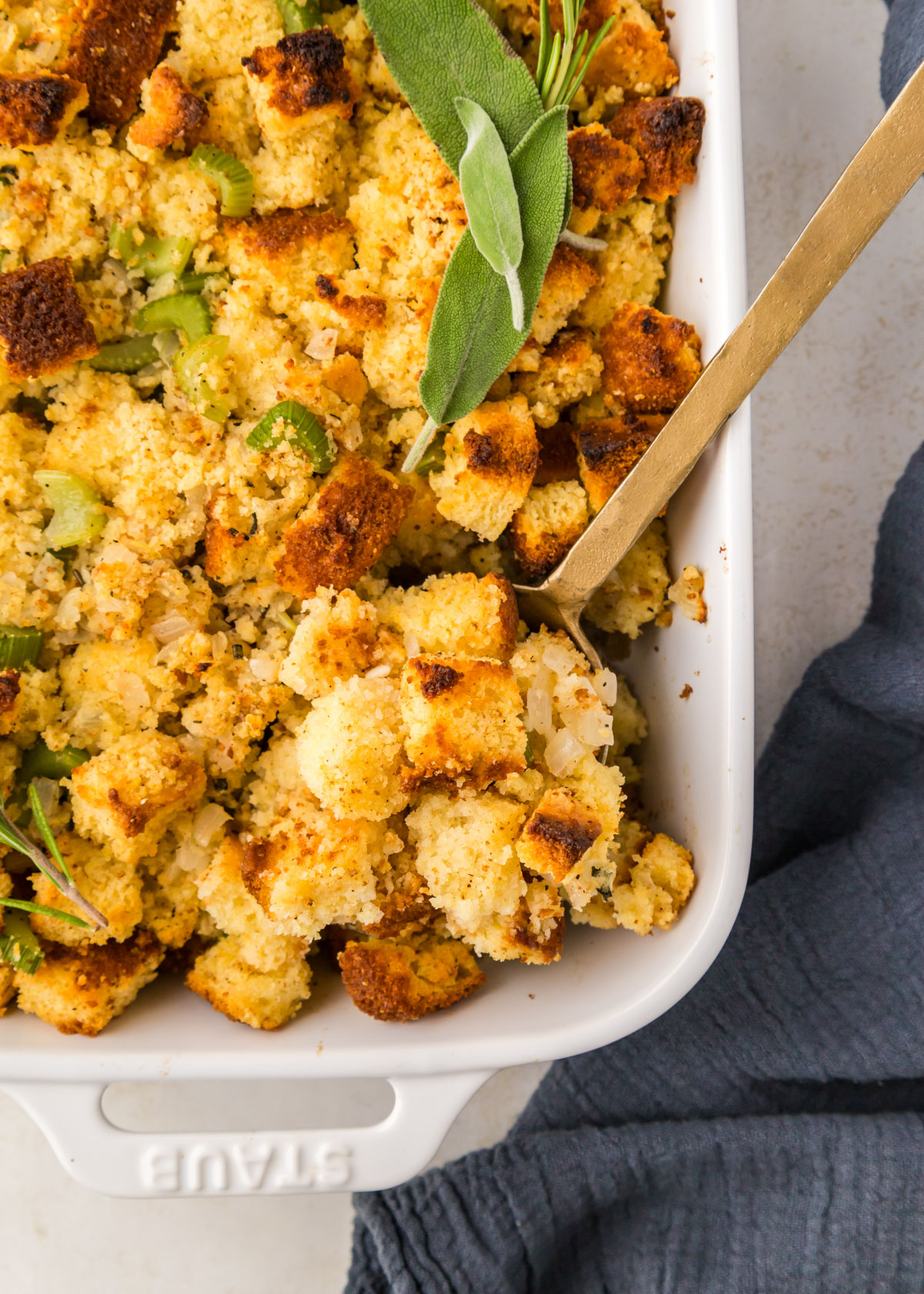 A spoon scoops out cornbread stuffing