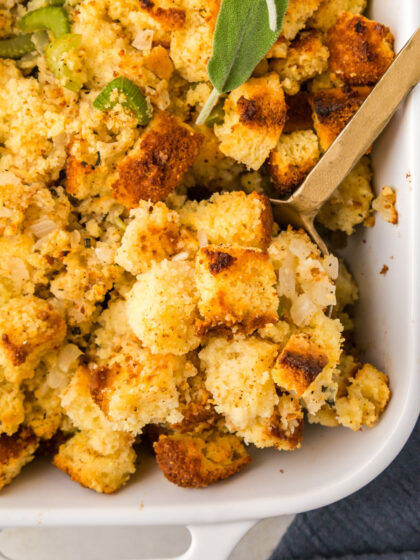 A spoon scoops out cornbread stuffing