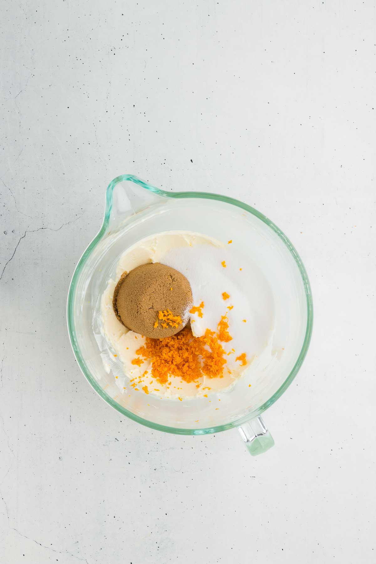 Adding the sugars and orange zest for Cranberry Orange White Chocolate Chip Cookies
