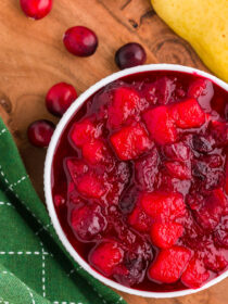 ginger pear cranberry sauce on a wooden table with a green napkin.
