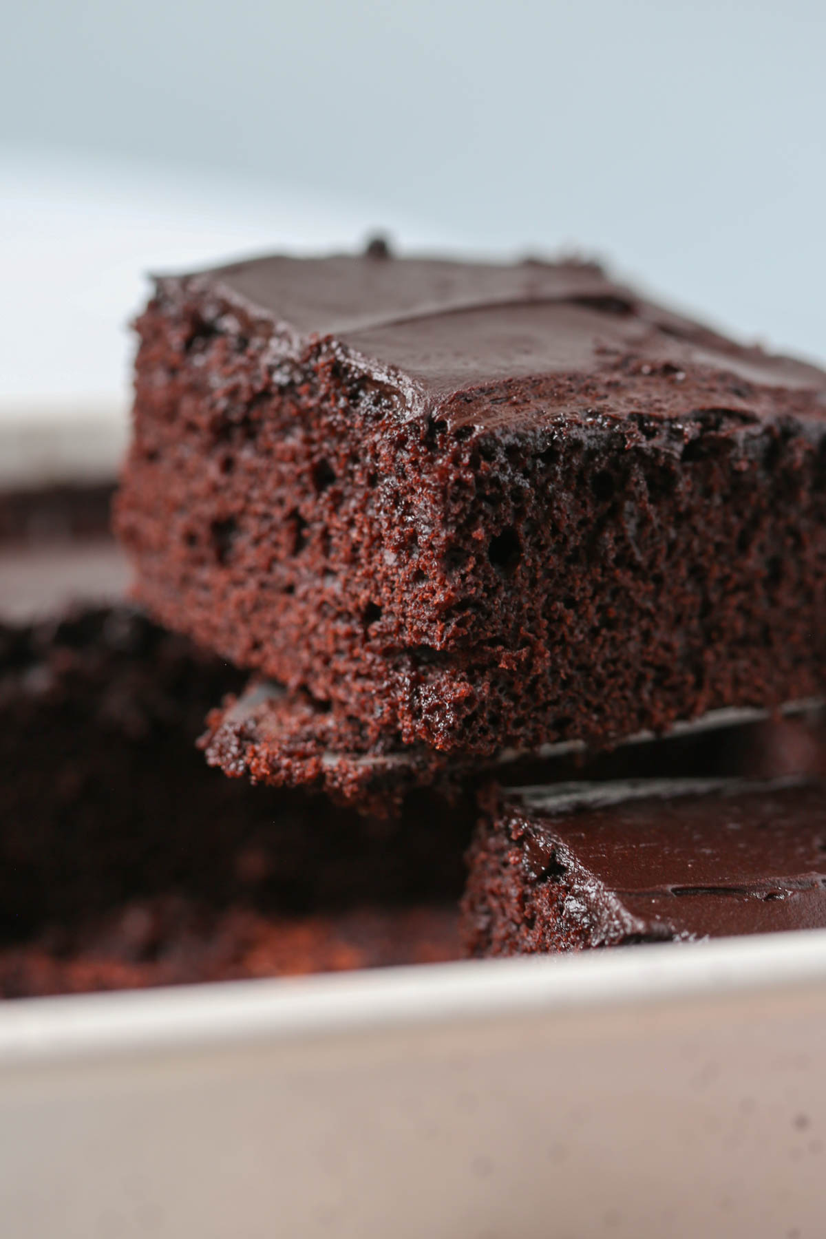 Pulling a piece of chocolate wacky cake out of the pan