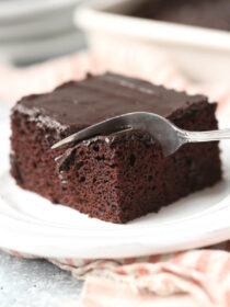 A fork cuts into a square of chocolate wacky cake
