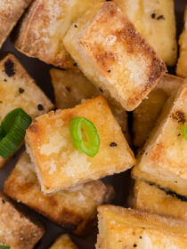 Close-up of crispy fried tofu with scallions