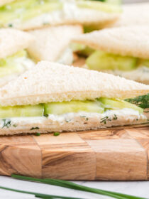 Side view of cucumber sandwich with dill on the side