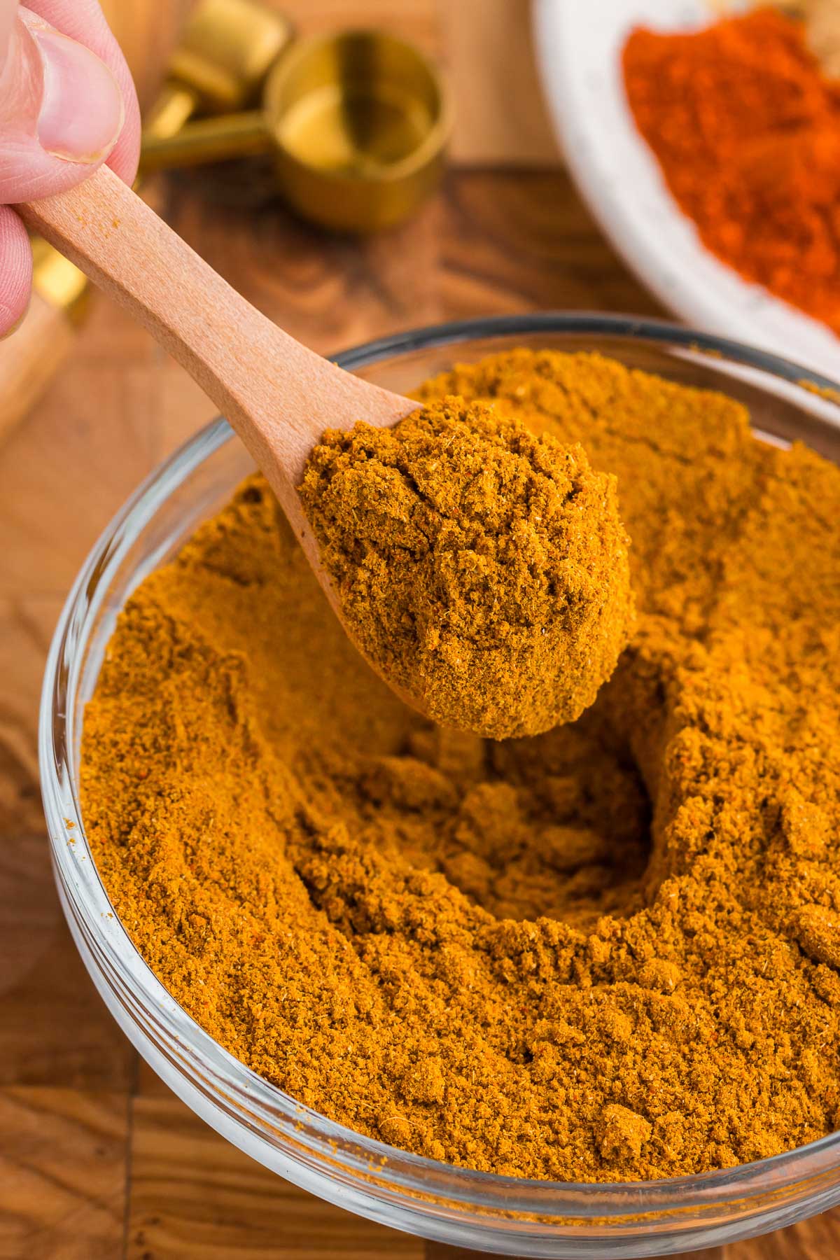 a glass bowl full of diy curry powder