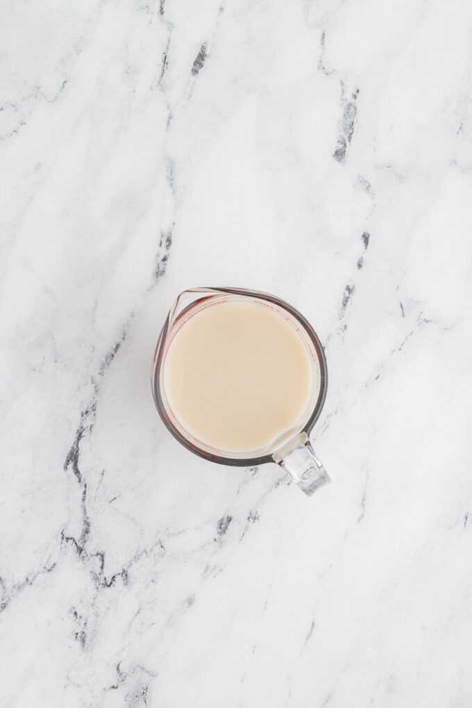 dairy free buttermilk in a glass mixing cup