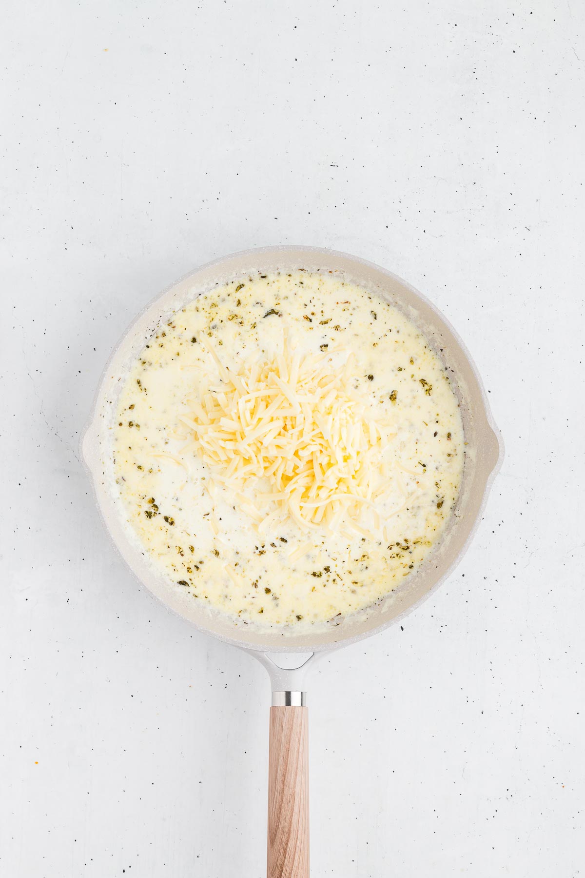 sauteeing garlic and seasonings for homemade alfredo sauce
