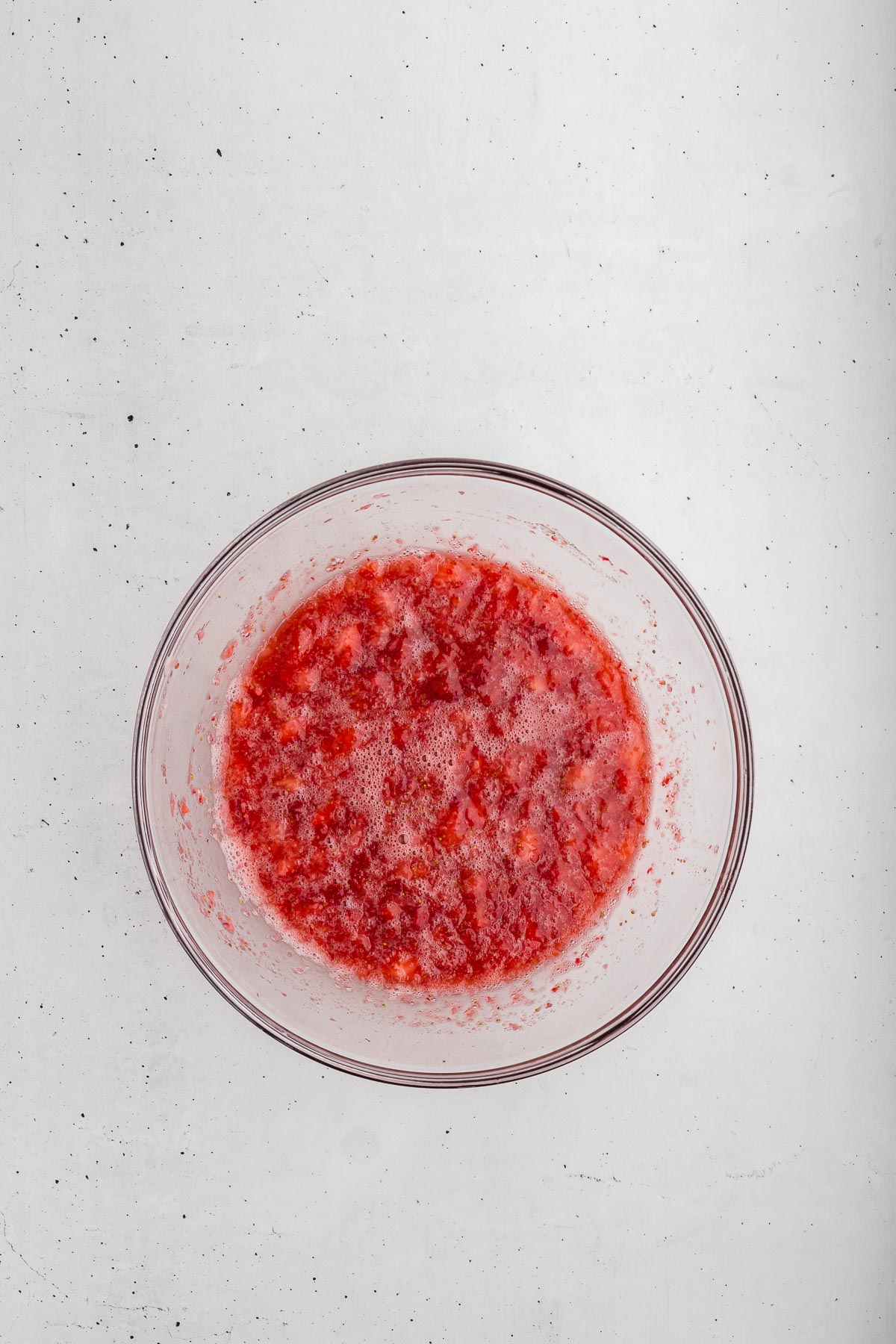 mashing strawberries for Easy Strawberry Lemonade