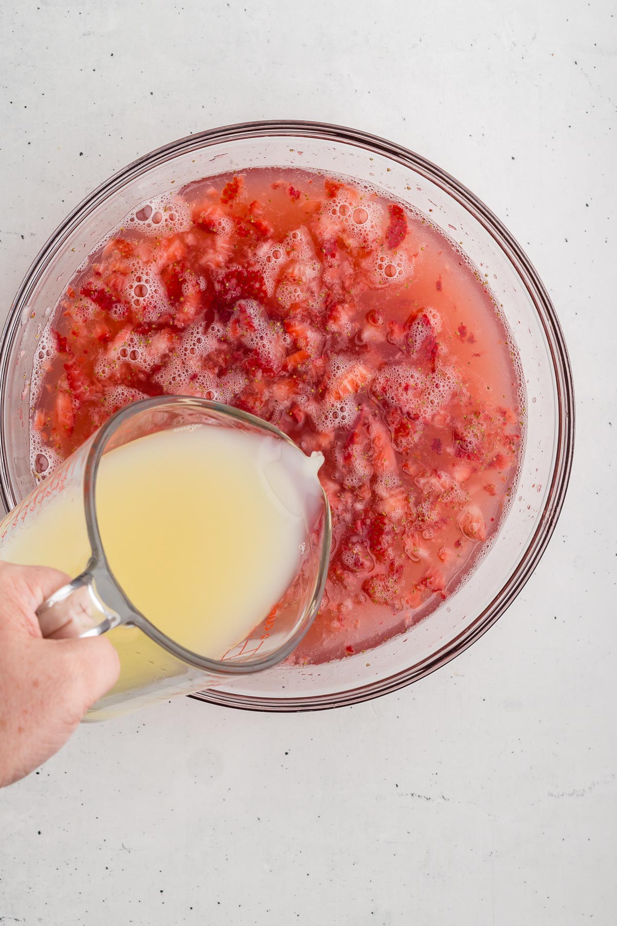 Adding lemon juice to Easy Strawberry Lemonade
