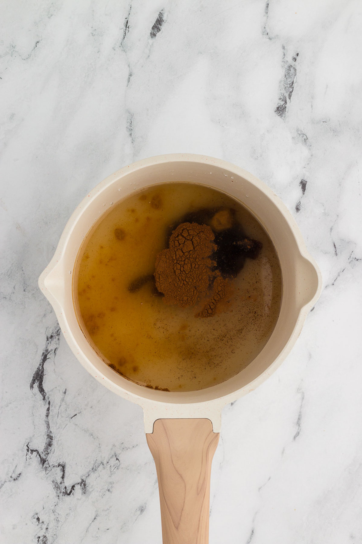 Simmering the ingredients for homemade gingerbread coffee syrup