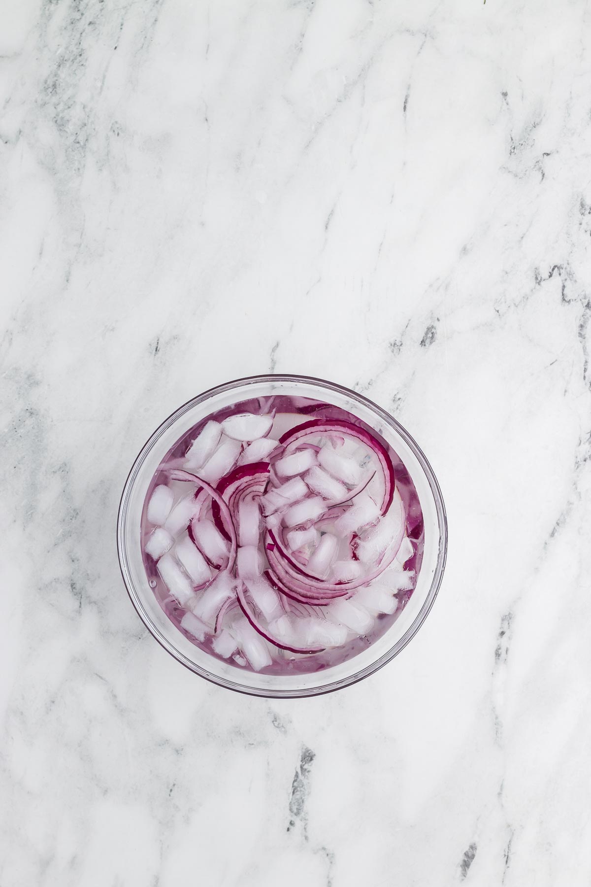 soaking the onions in ice water for Greek Mosaic Salad