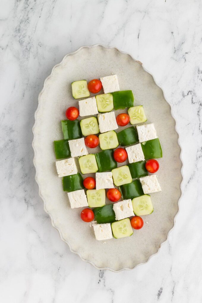 arranging veggies and feta cheese for Greek Mosaic Salad