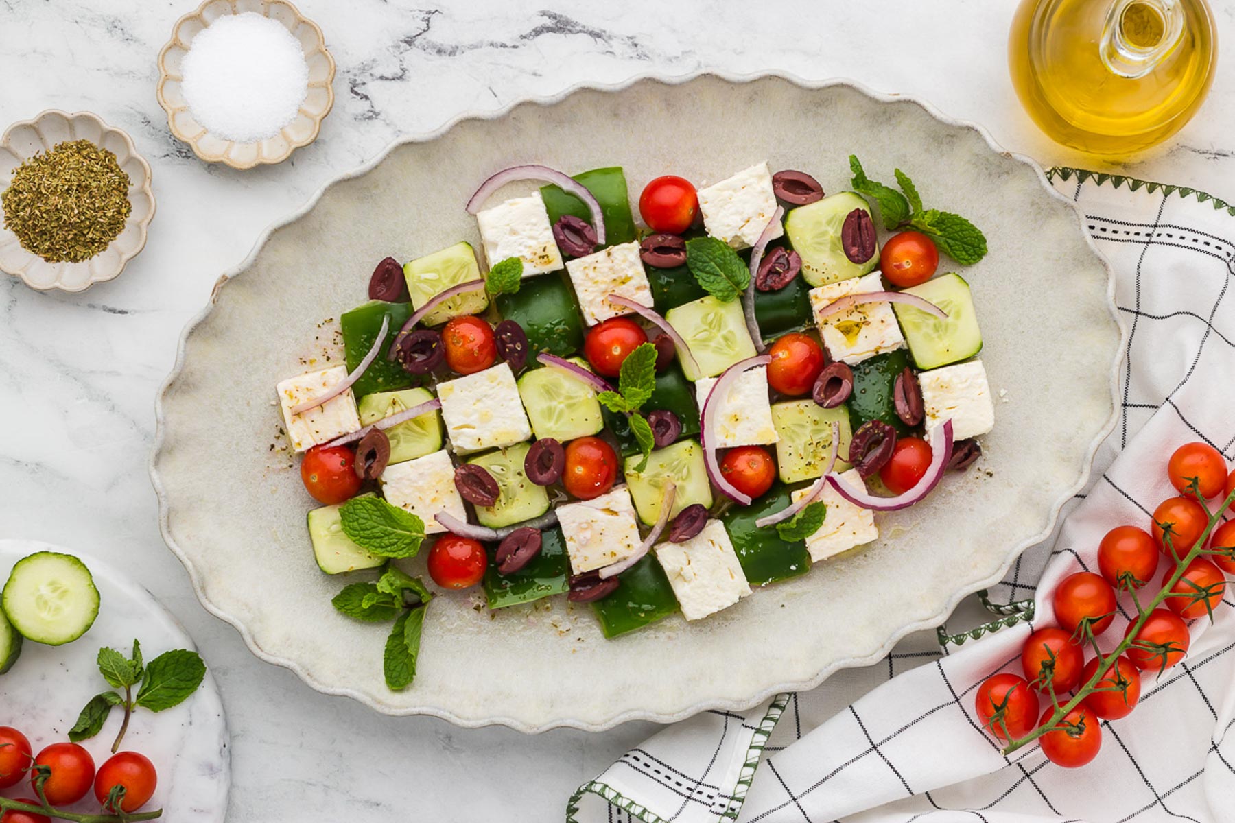 Greek Mosaic Salad on a ruffled white platter