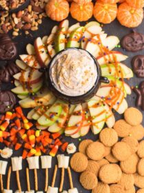 Halloween foods are arranged on a board to make a Halloween snack board.