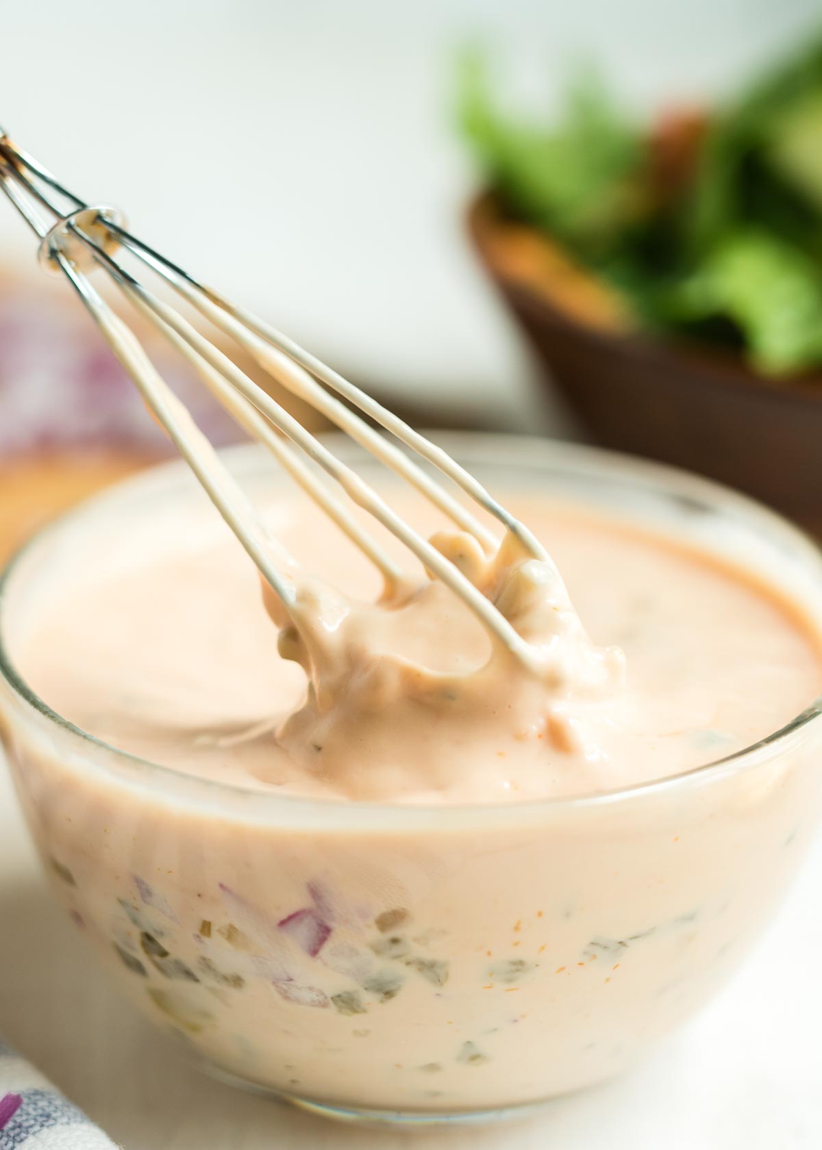 A bowl of Thousand Island salad dressing being whisked