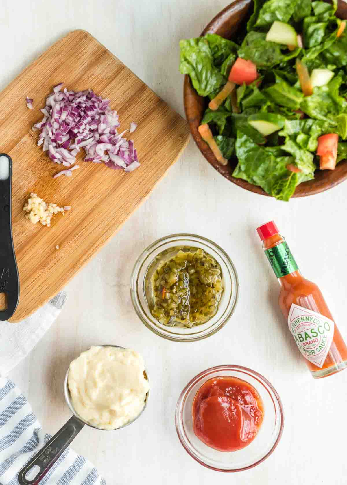 A salad plus ingredients for Thousand Island Dressing