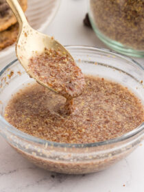 A gold spoon full of flax egg spilling out, showing how thick flax eggs are.