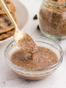 A gold spoon full of flax egg spilling out, showing how thick flax eggs are.