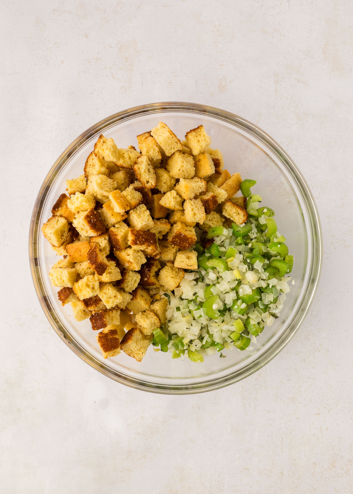 Cornbread stuffing ingredients in a bowl, ready to be combined.