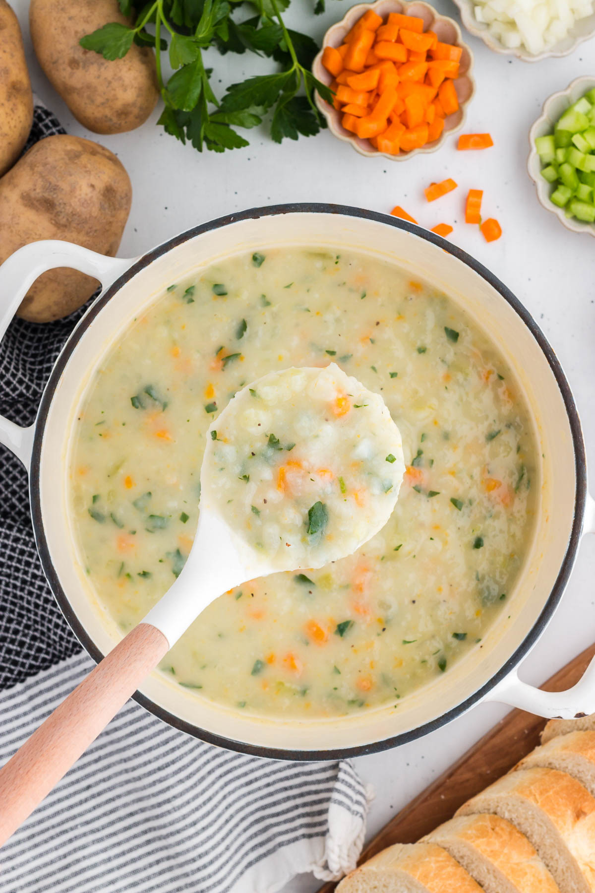 A ladle scoops out a serving of potato soup