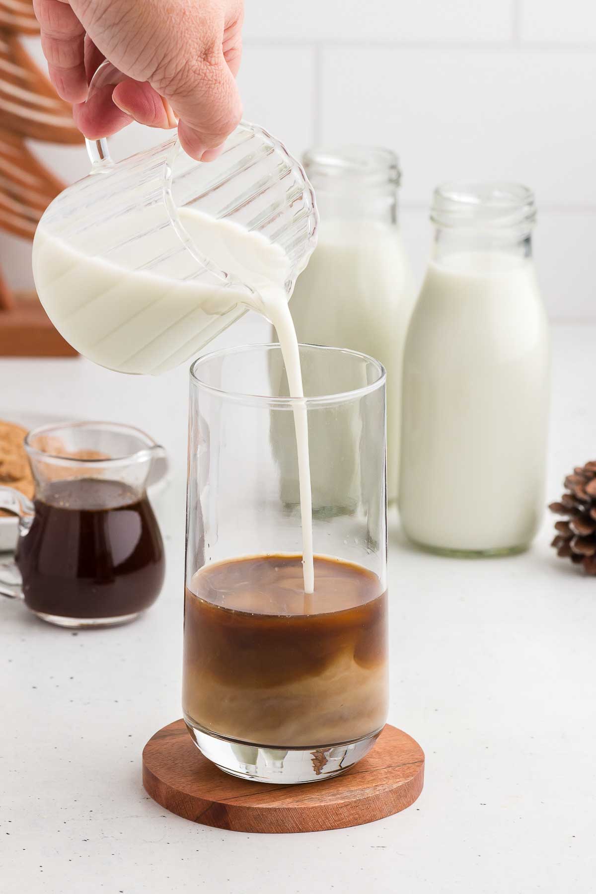 Pouring milk into a glass for a Gingerbread Iced Latte