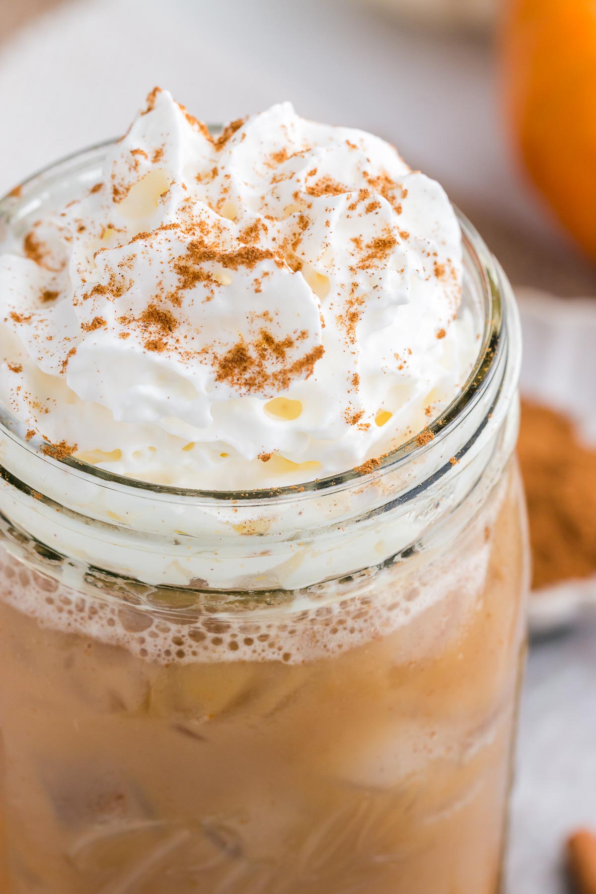 close up of Iced Pumpkin Spiced Latte in a mason jar