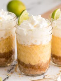 Three key lime pie jars with lime wedge garnishes