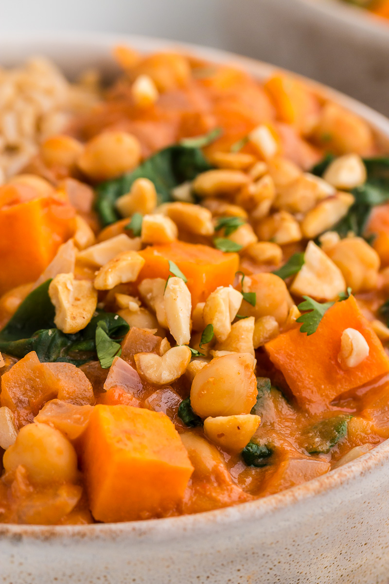 Close up of Slow Cooker Sweet Potato, Chickpea, & Peanut Stew in a white bowl