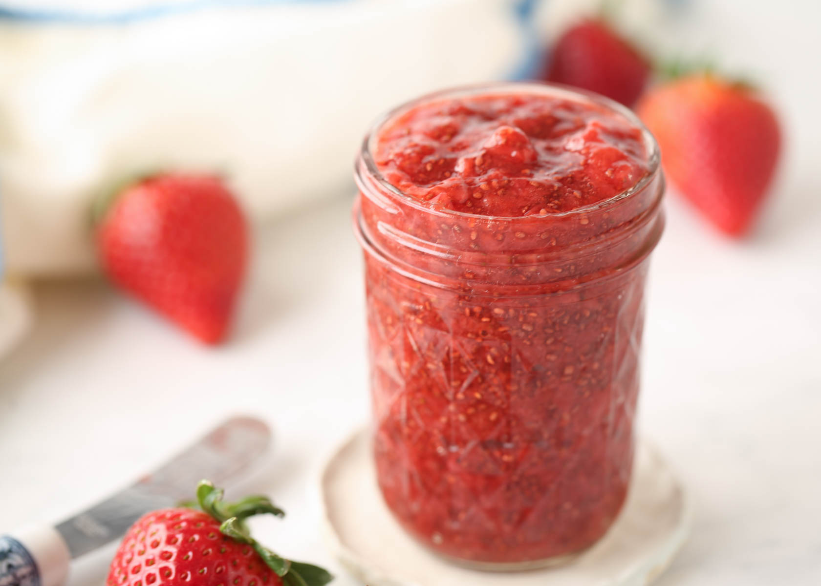A glass jar full of strawberry chia seed jam