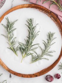 sugared rosemary in a bowl of sugar