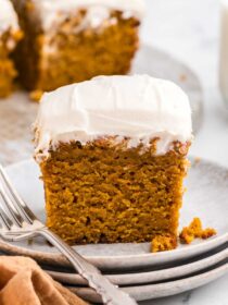 a square of Spiced Sweet Potato Cake on white plates with a silver fork
