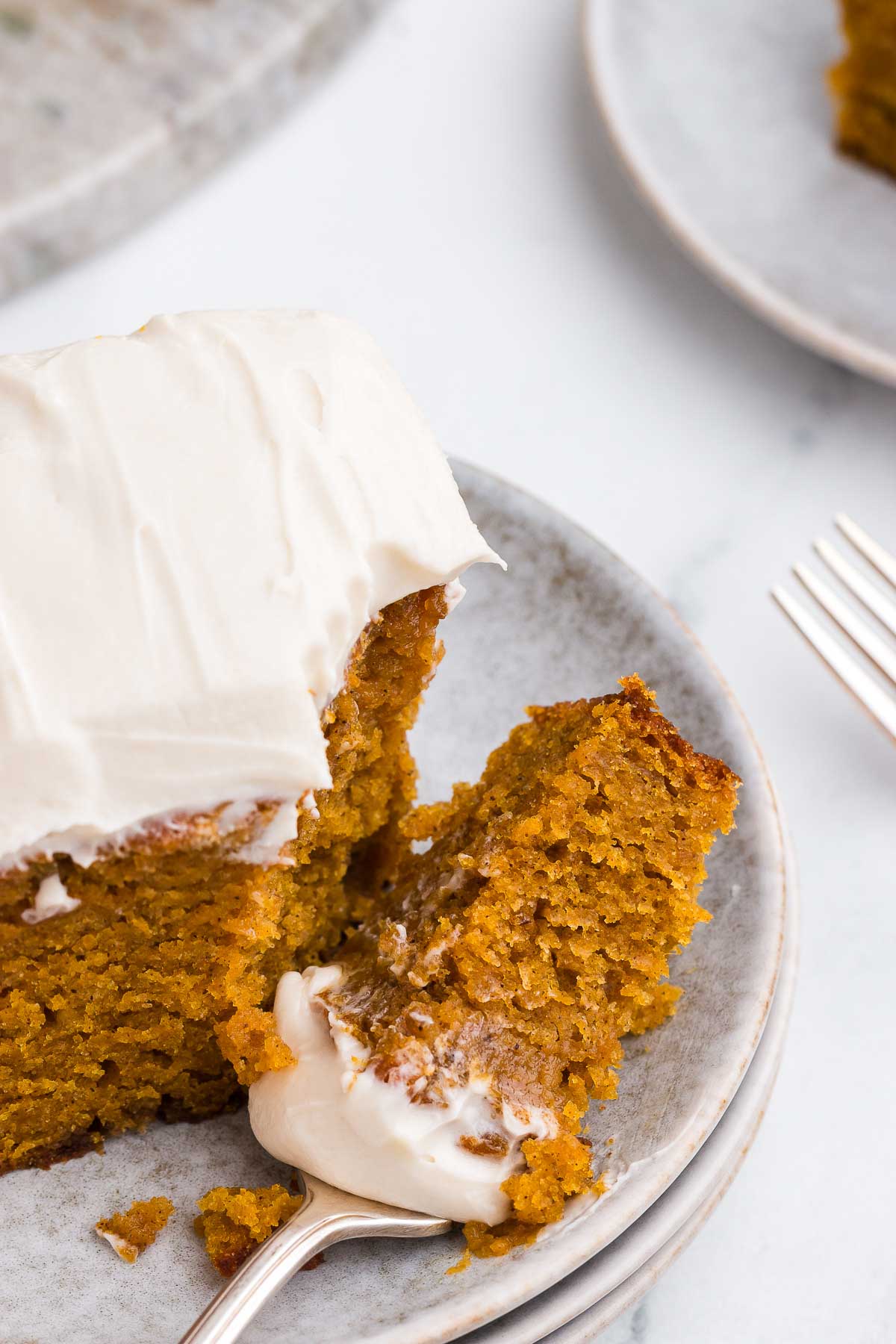 a fork cuts a bite of Spiced Sweet Potato Cake