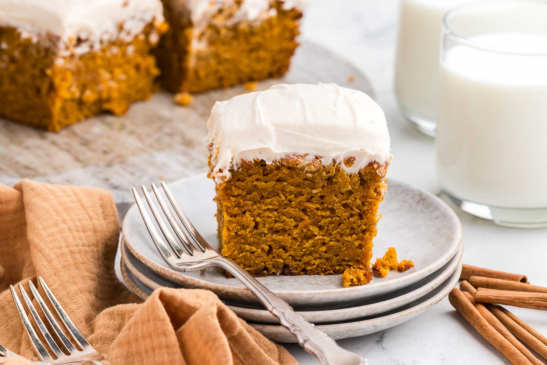 Spiced Sweet Potato Cake on a stack of white plates with a silver fork