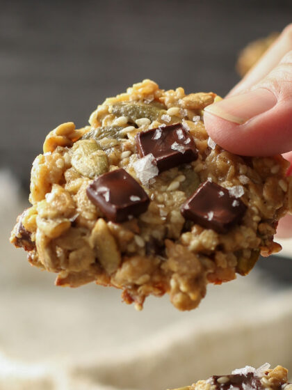 A hand holding a tahini seed cookie