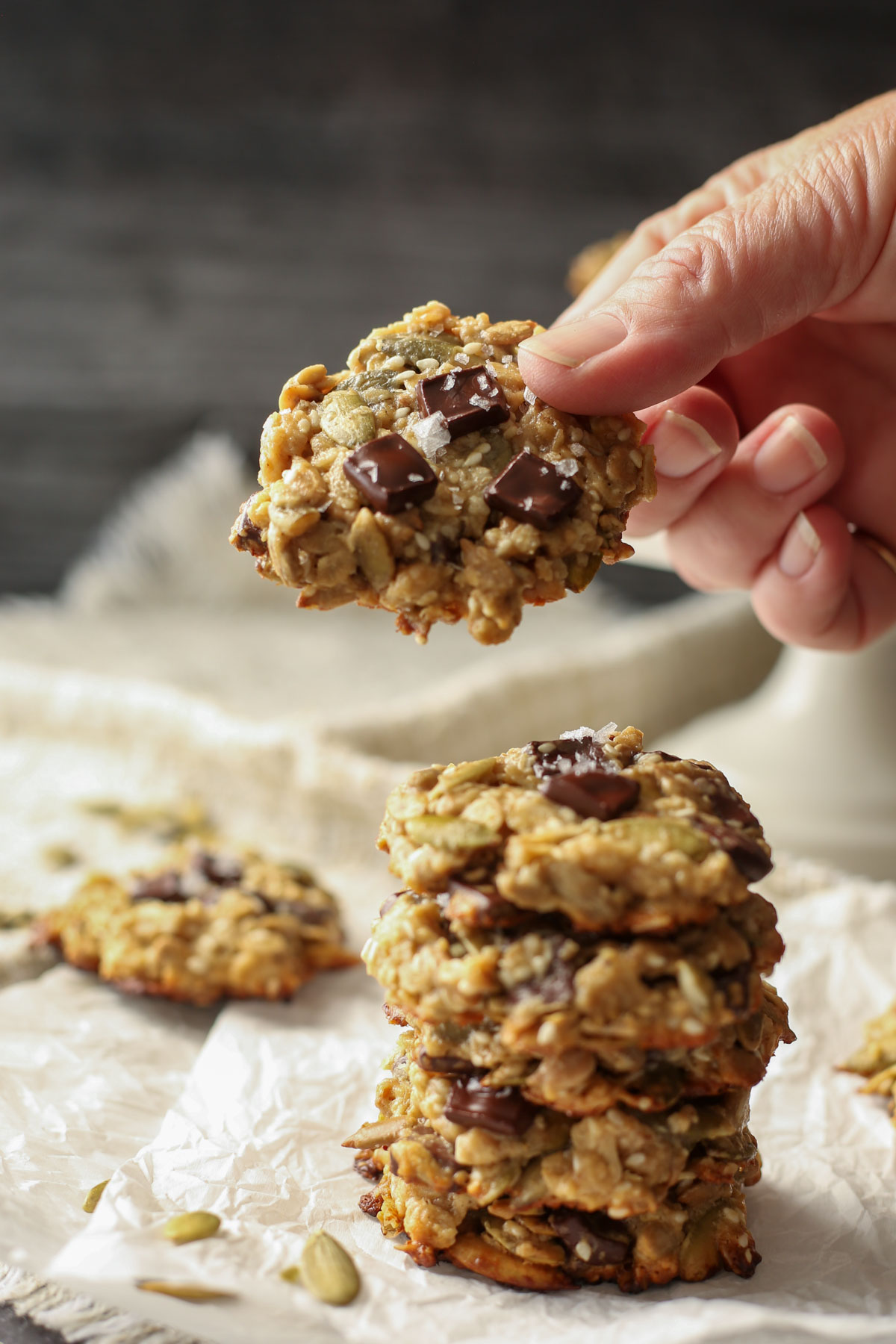 A hand holding a tahini seed cookie