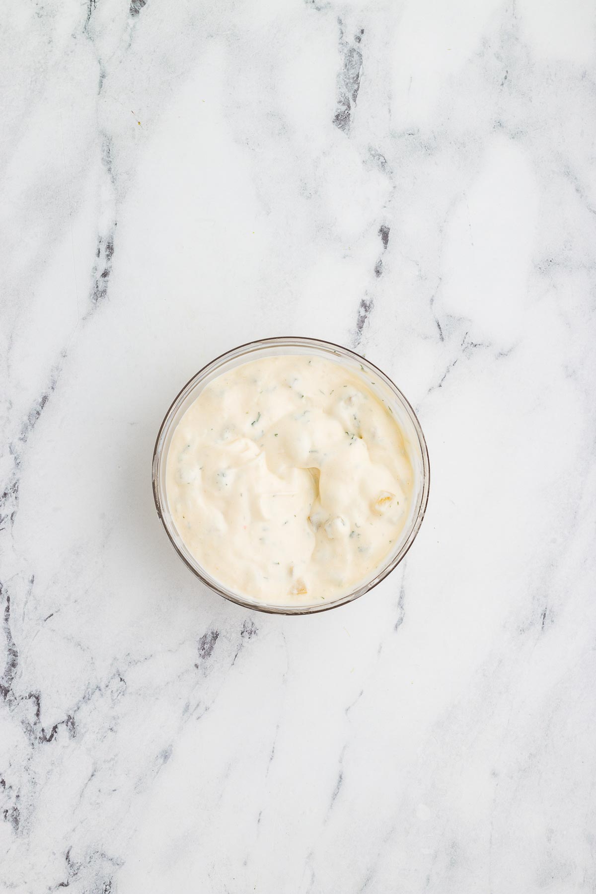 Tartar sauce being mixed up in a bowl