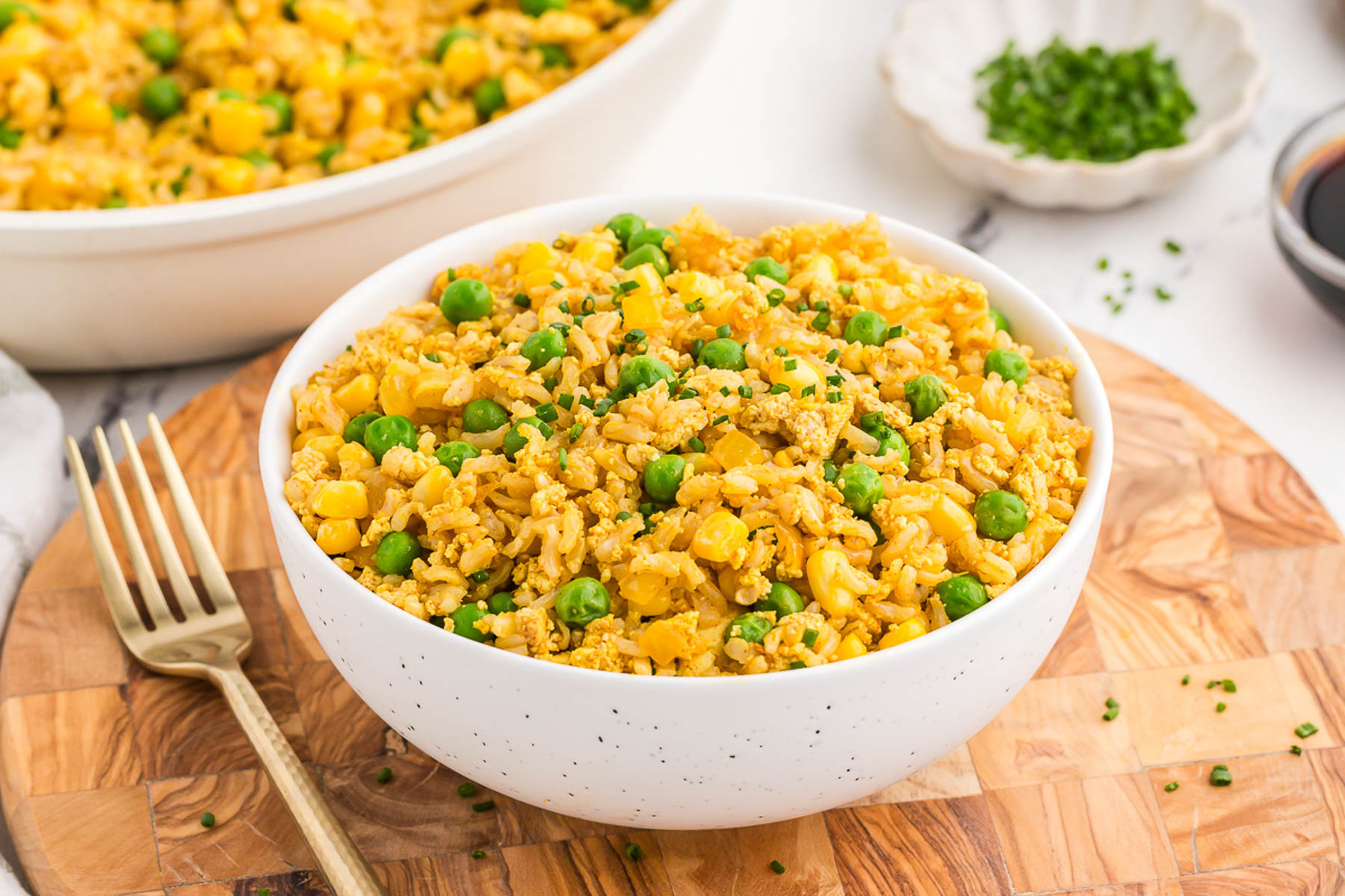 A white bowl full of tofu fried rice